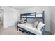 Cozy bedroom featuring a blue bunk bed frame, white walls, and carpet flooring at 11616 Little River Way, Parrish, FL 34219