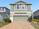Home exterior showcasing neutral siding, brick driveway, and a two-car garage at 11616 Little River Way, Parrish, FL 34219