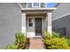 Charming entryway featuring a brick walkway, brown door, and meticulously landscaped front yard at 11616 Little River Way, Parrish, FL 34219