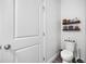 Clean half bathroom with decorative shelving and a modern toilet at 11616 Little River Way, Parrish, FL 34219