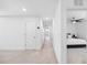 Hallway with neutral colors leading into a bedroom at 11616 Little River Way, Parrish, FL 34219
