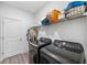 Functional laundry room with modern washer and dryer, shelving, and ample storage space at 11616 Little River Way, Parrish, FL 34219