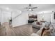 Bright open-concept floorplan featuring wood-look floors, staircase, and seamless flow to dining and kitchen at 11616 Little River Way, Parrish, FL 34219