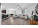 Spacious living room with a large window, ceiling fan, and comfortable seating at 11616 Little River Way, Parrish, FL 34219