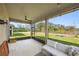 Relaxing screened-in patio with ceiling fan overlooking the green backyard at 11616 Little River Way, Parrish, FL 34219