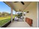 Covered patio with neutral color scheme, ceiling fan, and screened openings at 11616 Little River Way, Parrish, FL 34219