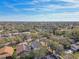 Community aerial view with spacious homes and beautiful tree coverage at 1764 Oak Spring Dr, Tarpon Springs, FL 34689