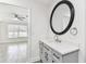 Elegant bathroom with modern vanity, framed mirror, and natural light near the bedroom at 1764 Oak Spring Dr, Tarpon Springs, FL 34689