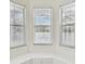 Bright bay window area with triple windows and wainscotting at 1764 Oak Spring Dr, Tarpon Springs, FL 34689