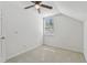 Bedroom with carpeted floors, ceiling fan, and a large window at 1764 Oak Spring Dr, Tarpon Springs, FL 34689