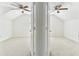 A bright bedroom with white walls, a ceiling fan, and carpeted floors at 1764 Oak Spring Dr, Tarpon Springs, FL 34689