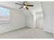 Spacious bedroom with carpeted floors, ceiling fan, and two windows at 1764 Oak Spring Dr, Tarpon Springs, FL 34689