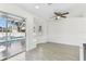 Bright breakfast nook featuring a ceiling fan, natural light, and sliding glass doors leading to the pool area at 1764 Oak Spring Dr, Tarpon Springs, FL 34689