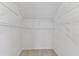 Walk-in closet with shelving and carpet at 1764 Oak Spring Dr, Tarpon Springs, FL 34689