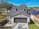 Charming home with gray trim, two-car garage, and a beautiful lawn at 1764 Oak Spring Dr, Tarpon Springs, FL 34689