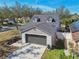 Charming home with gray trim, two-car garage and well maintained lawn at 1764 Oak Spring Dr, Tarpon Springs, FL 34689