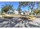Two-story home on a corner lot, showcasing mature trees, an attached garage, and well-maintained landscaping at 1764 Oak Spring Dr, Tarpon Springs, FL 34689