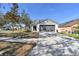 Charming single-Gathering home featuring a two-car garage and well-maintained front yard at 1764 Oak Spring Dr, Tarpon Springs, FL 34689