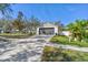 Charming single-Gathering home featuring a two-car garage and well-maintained front yard at 1764 Oak Spring Dr, Tarpon Springs, FL 34689