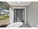 Elegant gray front door with decorative side windows and stylish trim, creating a welcoming entrance at 1764 Oak Spring Dr, Tarpon Springs, FL 34689