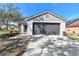 Charming home featuring an attached two-car garage and well-maintained front yard at 1764 Oak Spring Dr, Tarpon Springs, FL 34689