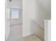 Hallway with carpeted floors, white walls and view into bedroom at 1764 Oak Spring Dr, Tarpon Springs, FL 34689