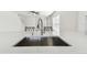 Modern kitchen boasts stainless steel sink, stylish faucet, and quartz countertop, perfect for any home chef at 1764 Oak Spring Dr, Tarpon Springs, FL 34689