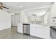 Open kitchen with white countertops and stainless steel appliances, flowing into dining area at 1764 Oak Spring Dr, Tarpon Springs, FL 34689
