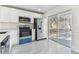 Modern kitchen features white cabinets, stainless appliances, and view to screened porch at 1764 Oak Spring Dr, Tarpon Springs, FL 34689