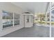 View of the screened patio and bay windows with backyard views at 1764 Oak Spring Dr, Tarpon Springs, FL 34689