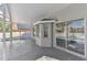 View of the screened patio with access to the backyard and bay windows at 1764 Oak Spring Dr, Tarpon Springs, FL 34689