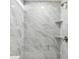 Modern shower with gray marble-look tile, shelving, and rainfall shower head at 1764 Oak Spring Dr, Tarpon Springs, FL 34689