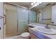 Bathroom features a shower with sliding glass door and a single sink vanity at 19701 Gulf Blvd # 328, Indian Shores, FL 33785
