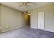 Cozy bedroom features a ceiling fan and neutral colored carpet at 19701 Gulf Blvd # 328, Indian Shores, FL 33785
