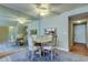 Cozy dining area featuring a mirrored wall and a ceiling fan, with seating for four at 19701 Gulf Blvd # 328, Indian Shores, FL 33785