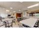 Spacious dining area with tables and chairs, next to a kitchen area at 19701 Gulf Blvd # 328, Indian Shores, FL 33785