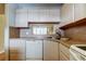 Well-lit kitchen featuring light wood cabinets and countertops, with essential appliances at 19701 Gulf Blvd # 328, Indian Shores, FL 33785