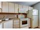 A well-lit kitchen featuring a standard refrigerator and appliance package at 19701 Gulf Blvd # 328, Indian Shores, FL 33785