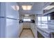 Bright kitchen with white cabinetry, tile floors, and stainless appliances at 19701 Gulf Blvd # 328, Indian Shores, FL 33785