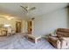 Spacious living room with cozy armchair, dining area, ceiling fan, and access to hallway at 19701 Gulf Blvd # 328, Indian Shores, FL 33785
