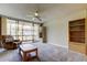 Bright living room with a ceiling fan, cozy recliner, and sliding glass doors to a screened in balcony at 19701 Gulf Blvd # 328, Indian Shores, FL 33785