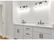 Bathroom featuring double vanity with quartz countertop and modern lighting at 2436 Jacobs St, Port Charlotte, FL 33953