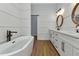 Elegant bathroom featuring double vanity, oval mirrors and a freestanding tub at 2436 Jacobs St, Port Charlotte, FL 33953