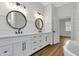 Luxurious bathroom showcasing double vanity, modern mirrors and a freestanding tub at 2436 Jacobs St, Port Charlotte, FL 33953
