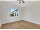 Comfortable bedroom featuring wood floors and a bright window overlooking the yard at 2436 Jacobs St, Port Charlotte, FL 33953