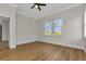 Bedroom featuring hardwood flooring, bright window and a ceiling fan at 2436 Jacobs St, Port Charlotte, FL 33953