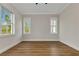 Spacious bedroom with wood floors, neutral paint, and sun-filled windows at 2436 Jacobs St, Port Charlotte, FL 33953