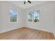 Light-filled bedroom featuring wood floors and large windows with scenic views at 2436 Jacobs St, Port Charlotte, FL 33953
