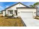 Charming single-Gathering home featuring a well-manicured lawn, two-car garage, and stone accents at 2436 Jacobs St, Port Charlotte, FL 33953