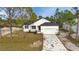 Gorgeous home with paved driveway, attached garage, and perfectly manicured landscaping at 2436 Jacobs St, Port Charlotte, FL 33953